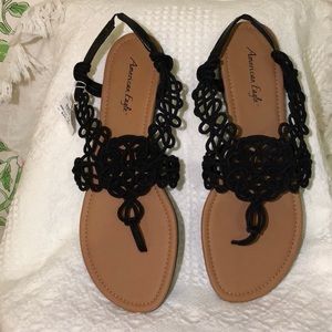 Size 13 never fit and never worn. American eagle black and tan sandals.
